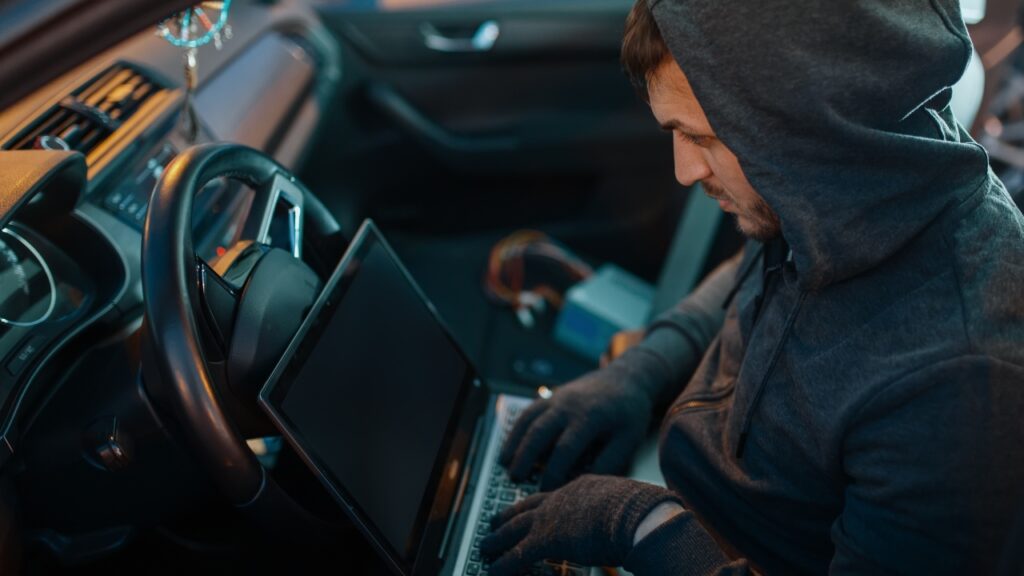 car-thief-with-laptop-hacking-security-system